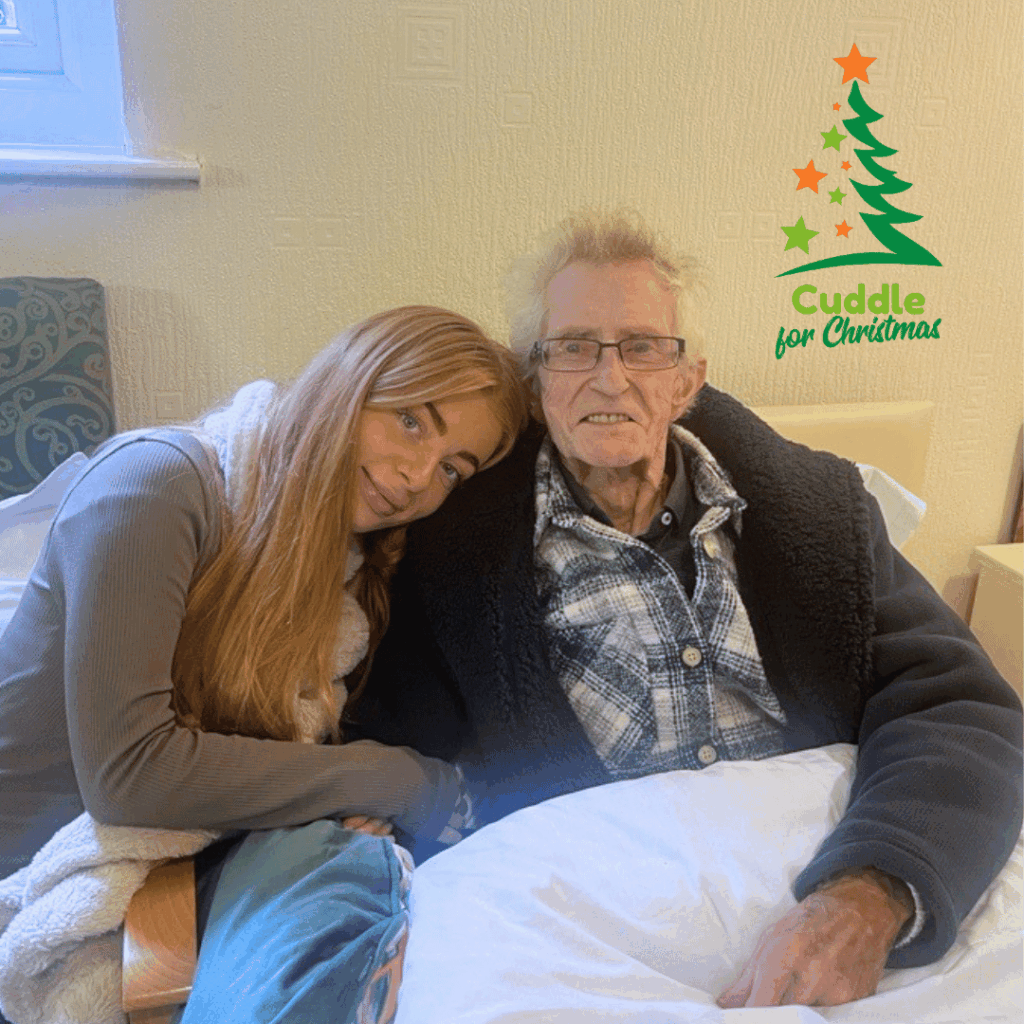 Patient cuddling family in a hospice bed